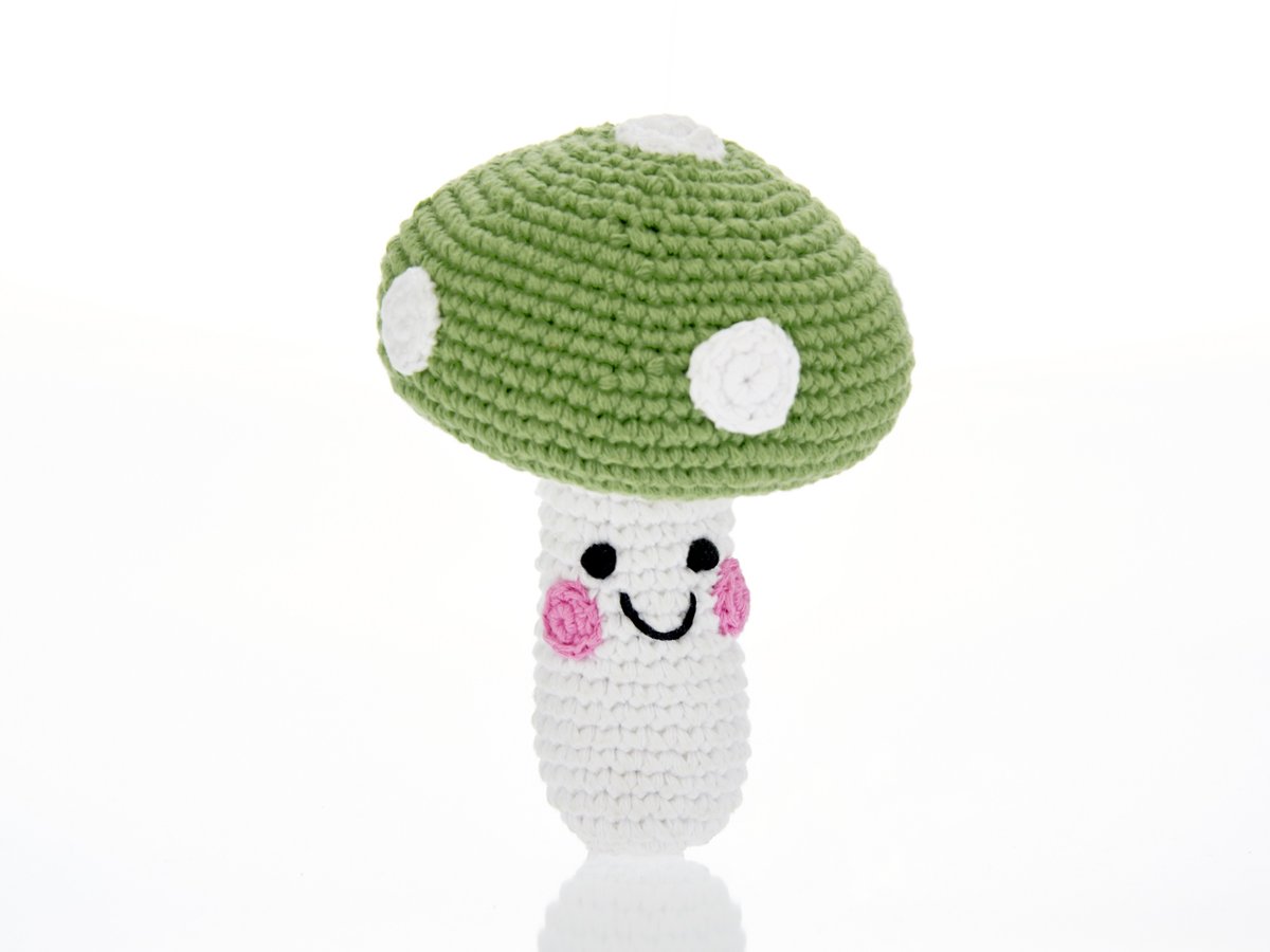 Crochet toadstool baby toy with white stalk and smiley face and green cap with white dots