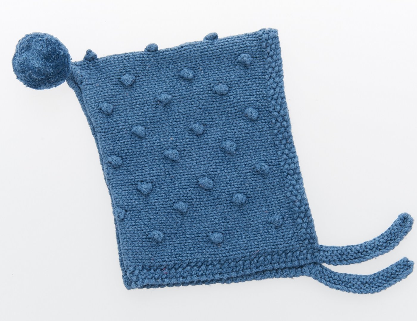 Petrol blue coloured knitted baby bonnet with bobbles in the pattern, bobble on topy and ties for under the chin