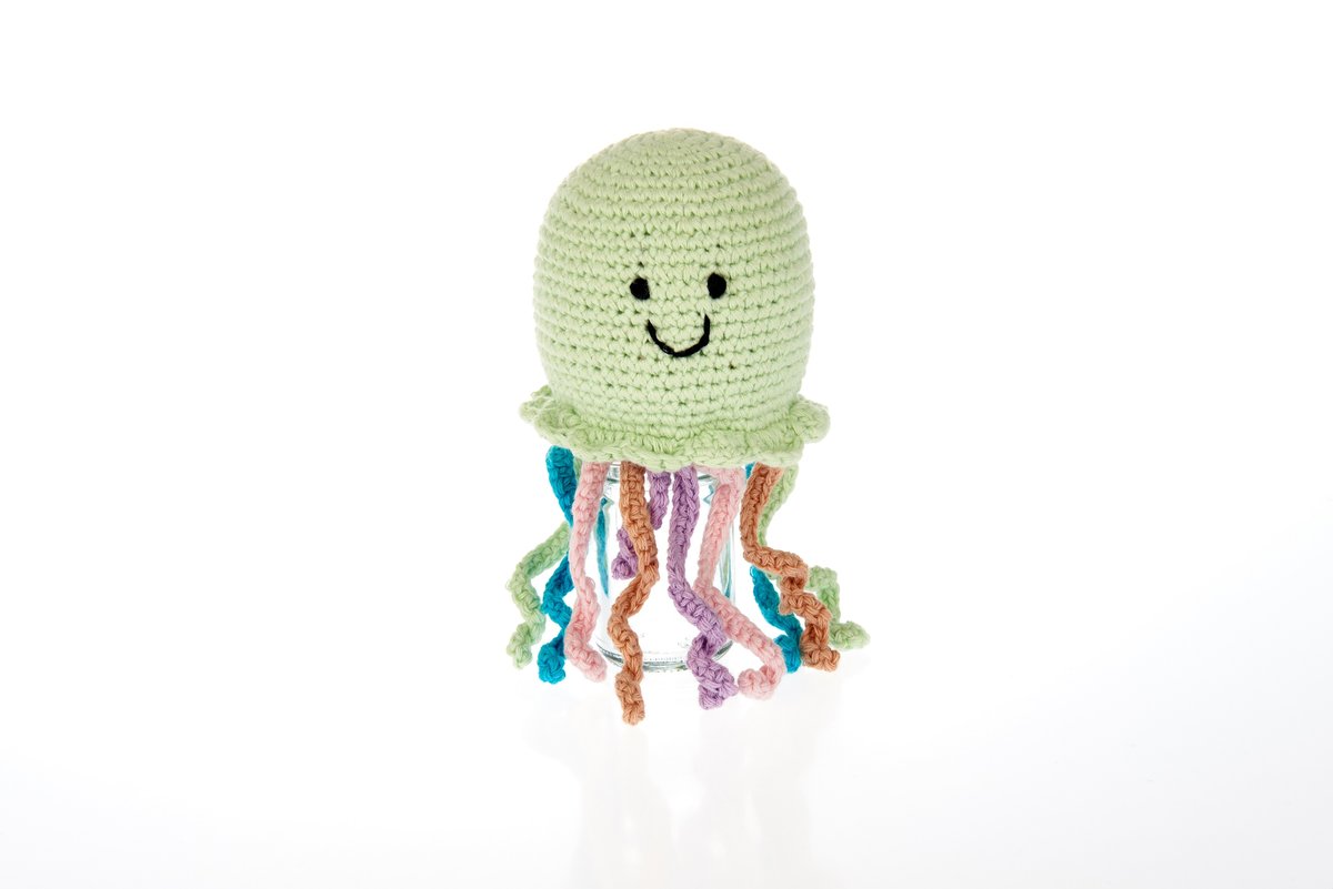 Crochet cotton jellyfish baby rattle with green body, smiley face and colourful tentacles